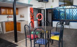a dining room with a table and chairs in a kitchen at Hotel Perla Azul Girardot in Girardot