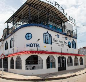 a building with a clock on the top of it at Hotel Perla Azul Girardot in Girardot