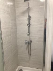 a shower with a glass door in a bathroom at Chez titi et carole in Dissay-sous-Courcillon