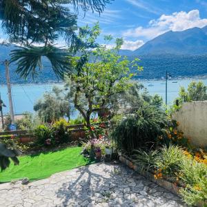 a garden with flowers and a view of the water at Christina's Sea View House in Yénion