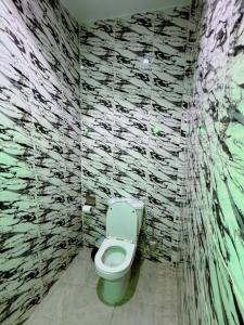 a bathroom with a toilet in a stone wall at Grand Studio Cosy in Cocody +10 photos