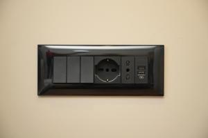 a microwave on a wall with a face on it at Green Park Divjake in Divjakë