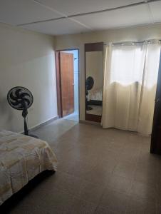 a bedroom with a bed and a room with a door at Olaya Point BAQ in Barranquilla