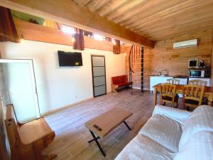 a living room with a couch and a table at Domaine de buffevent in Cintegabelle