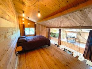 a bedroom with a large bed in a room with wooden floors at Domaine de buffevent in Cintegabelle +56 photos