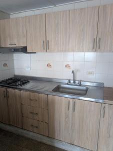 a kitchen with a sink and a stove at Olaya Point BAQ in Barranquilla