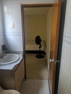 a bathroom with a sink and a fan in a room at Olaya Point BAQ in Barranquilla