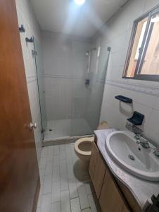 a bathroom with a shower and a toilet and a sink at Olaya Point BAQ in Barranquilla
