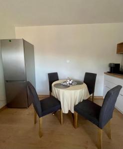 a kitchen with a table with chairs and a refrigerator at Dafni's Nest, Nafpaktos in Nafpaktos