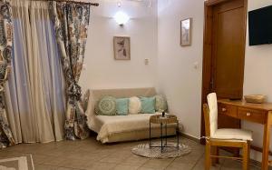 a room with a bed with a desk and a chair at Alexandra's House in Skiathos