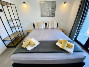 a bedroom with a large bed with towels on it at Spacious, Newly Renovated, Pula Rooftop Apartment with Marina Views in Pula