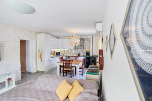 a living room with a couch and a kitchen at House Mellifera in Razvođe