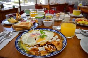 a table with a breakfast of eggs and toast at Suites Gaby Cancun in Cancún