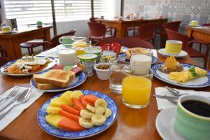 a table with plates of breakfast foods and drinks at Suites Gaby Cancun in Cancún