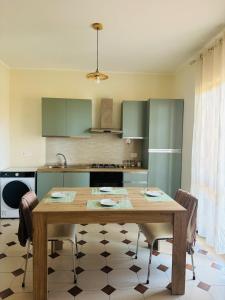 a kitchen with a wooden table in a kitchen at Villa Domini in Soverato Marina