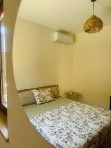 a bedroom with a bed with a round window at Villa Domini in Soverato Marina
