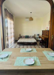 a living room with two tables and a couch at Villa Domini in Soverato Marina +11 photos