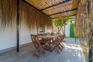 a wooden table and chairs on a patio at Nar Suites Alacati in Çeşme