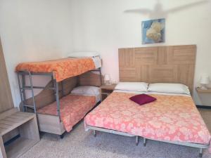 a room with two bunk beds and a bed at Pensione Fiorella Rimini in Rimini