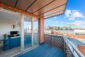 a balcony with a view of a building at Modern 2 Bedroom Flat with FREE Parking, Close to Heathrow and Thorpe Park in Staines