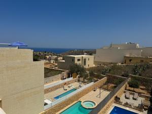 a view of a swimming pool from a building at Sea Views Penthouse Apartment in Xagħra