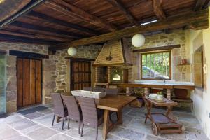 a kitchen with a table and chairs and a stove at Jardín Botánico in Lloreda +183 photos