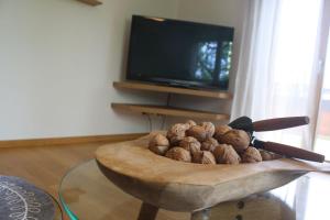 a bowl of nuts in front of a television at Sonnseite in Punschern in Teisendorf