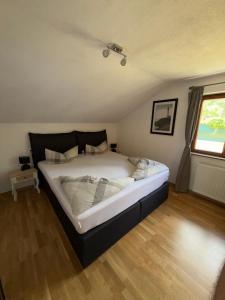 a bedroom with a large bed in a room at Haus Waldfrieden in Sautens