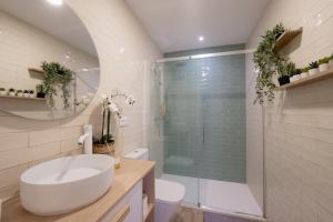 a bathroom with a white sink and a shower at Baélia Casa Serena in San Rafael +20 photos