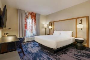 a hotel room with a bed and a desk at Fairfield Inn by Marriott Ponca City in Ponca City +17 photos