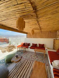 a living room with a couch and a table at Coastal Haven Surf Morocco in Aourir