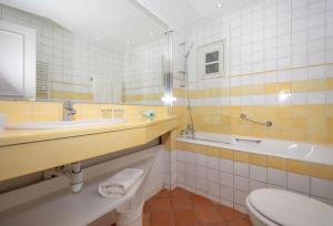 a bathroom with a sink and a toilet and a tub at hôtel Sube in Saint-Tropez +59 photos