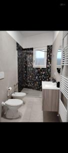 a bathroom with a toilet and a sink at Casa vacanza Lea in Veglie