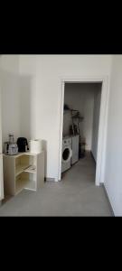 a white room with a washing machine and a microwave at Casa vacanza Lea in Veglie