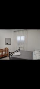 a bedroom with a bed and a window at Casa vacanza Lea in Veglie