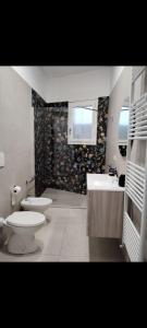 a bathroom with two toilets and a sink at Casa vacanza Lea in Veglie