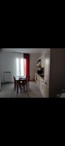 a kitchen and dining room with a table and chairs at Casa vacanza Lea in Veglie