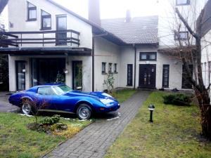 a blue car parked in front of a house at Vilnius Luxury Apartment 3 in Vilnius