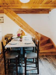 a dining room with a table and some chairs at Vrakades - Guest House in Kouniádhoi +9 photos