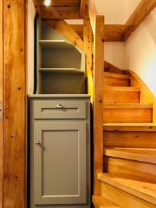 a small refrigerator in a room with stairs at Vrakades - Guest House in Kouniádhoi