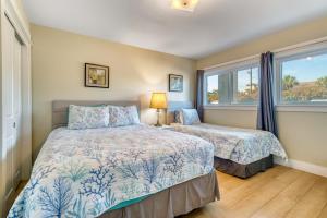 a bedroom with two beds and a window at Beach House Condominiums C103 - Beachfront with Pool, Wi-Fi, & Beach Service in Destin