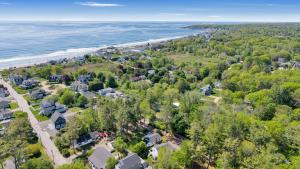 an aerial view of a subdivision of houses and the ocean at Cornish Cottage Walk to Long Sands Beach in York