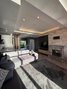 a living room with a couch and a fireplace at North Star Resort Hotel in Of