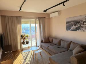 a living room with a couch and a table at Apartment N6 Shkoder in Shkodër