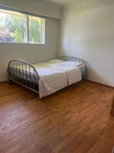 a bedroom with two beds and a wooden floor at 6 bedroom house in Victoria