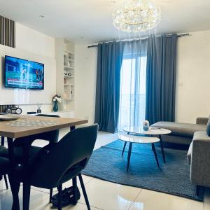 a living room with a chandelier and a dining room at Loxwood by Tripview Apartments in Accra
