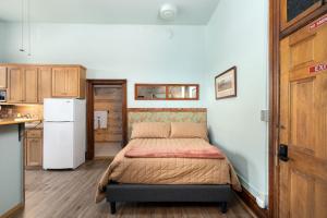a small bedroom with a bed and a kitchen at Del Norte Colorado Stone Quarry Studio Apt in Del Norte +8 photos