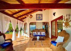 a living room with chairs and a couch on a porch at Magic Mountain Views Villa in Atenas