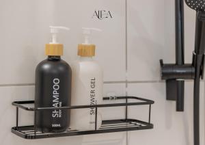 two bottles on a shelf in a bathroom at ALEA-Apartment - Bad Wildbad in Bad Wildbad