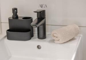 a bathroom sink with a faucet and a towel at ALEA-Apartment - Bad Wildbad in Bad Wildbad